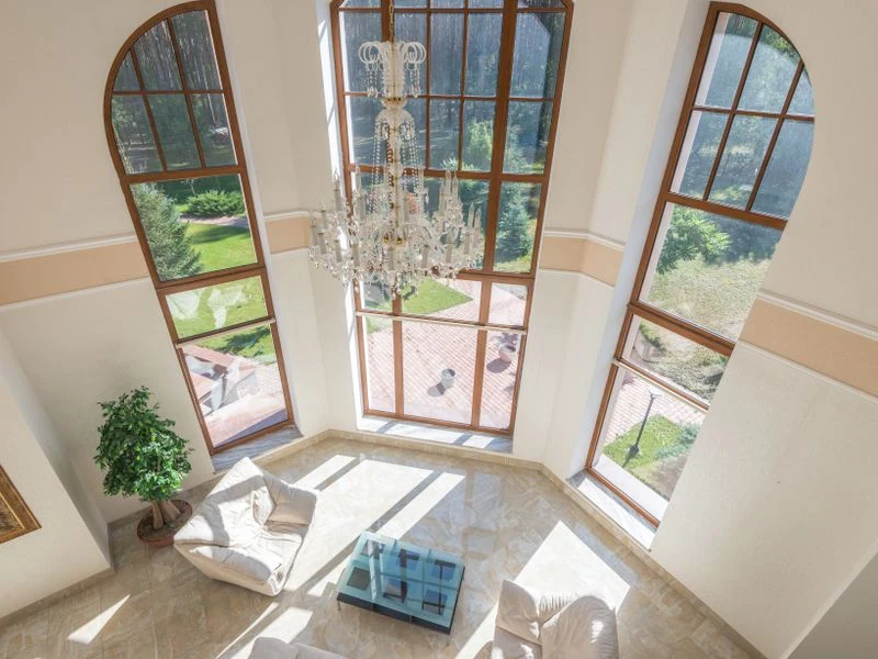 Automated shades fitted to tall arched windows