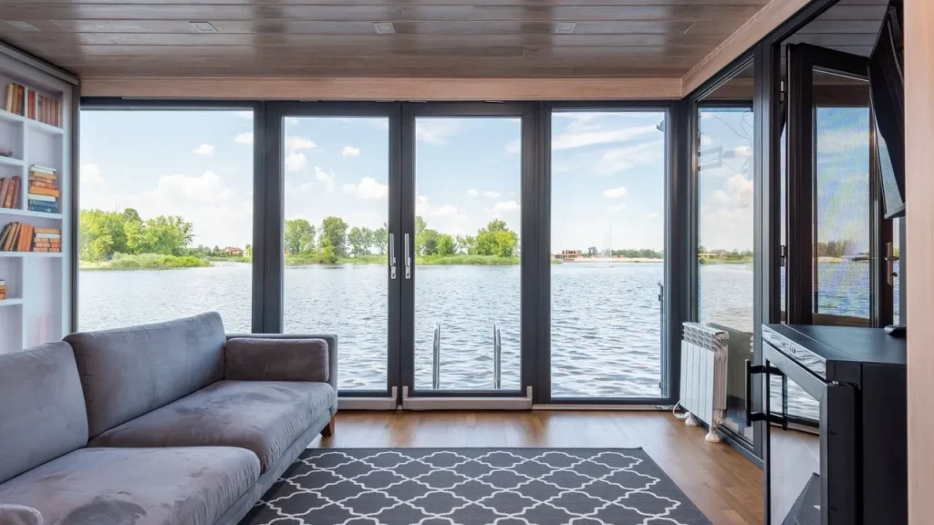 Custom shades fitted to floor to ceiling windows with a lake view