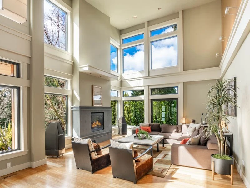 Custom shades on tall windows in a bright living space