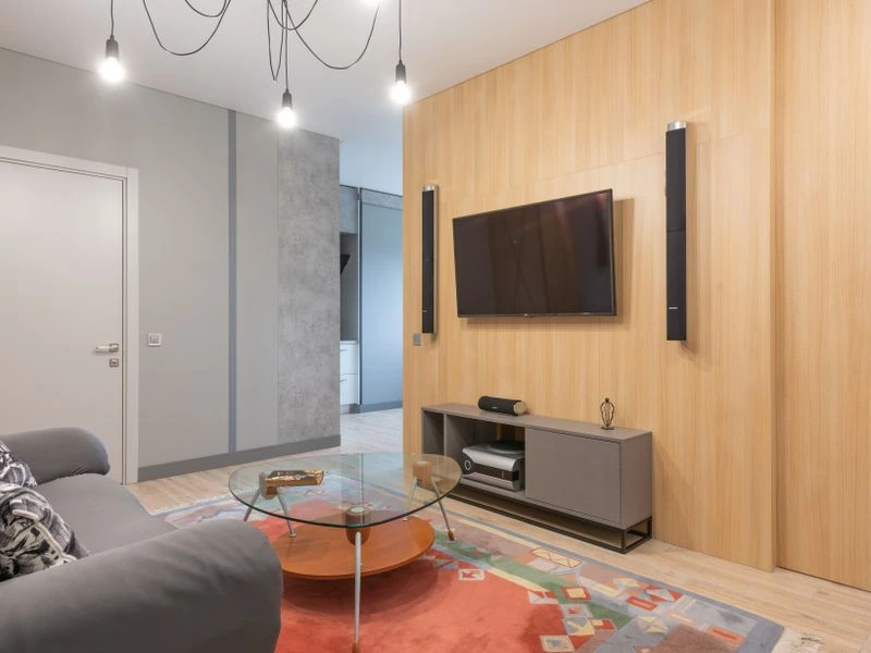 Wall-mounted surround sound speakers integrated into a home cinema room - McLean